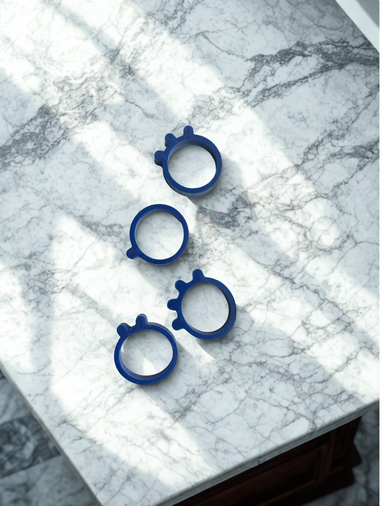 Pheelio tactile ring attached to an eye drop bottle, showing the ridged texture that helps users identify their medication by touch