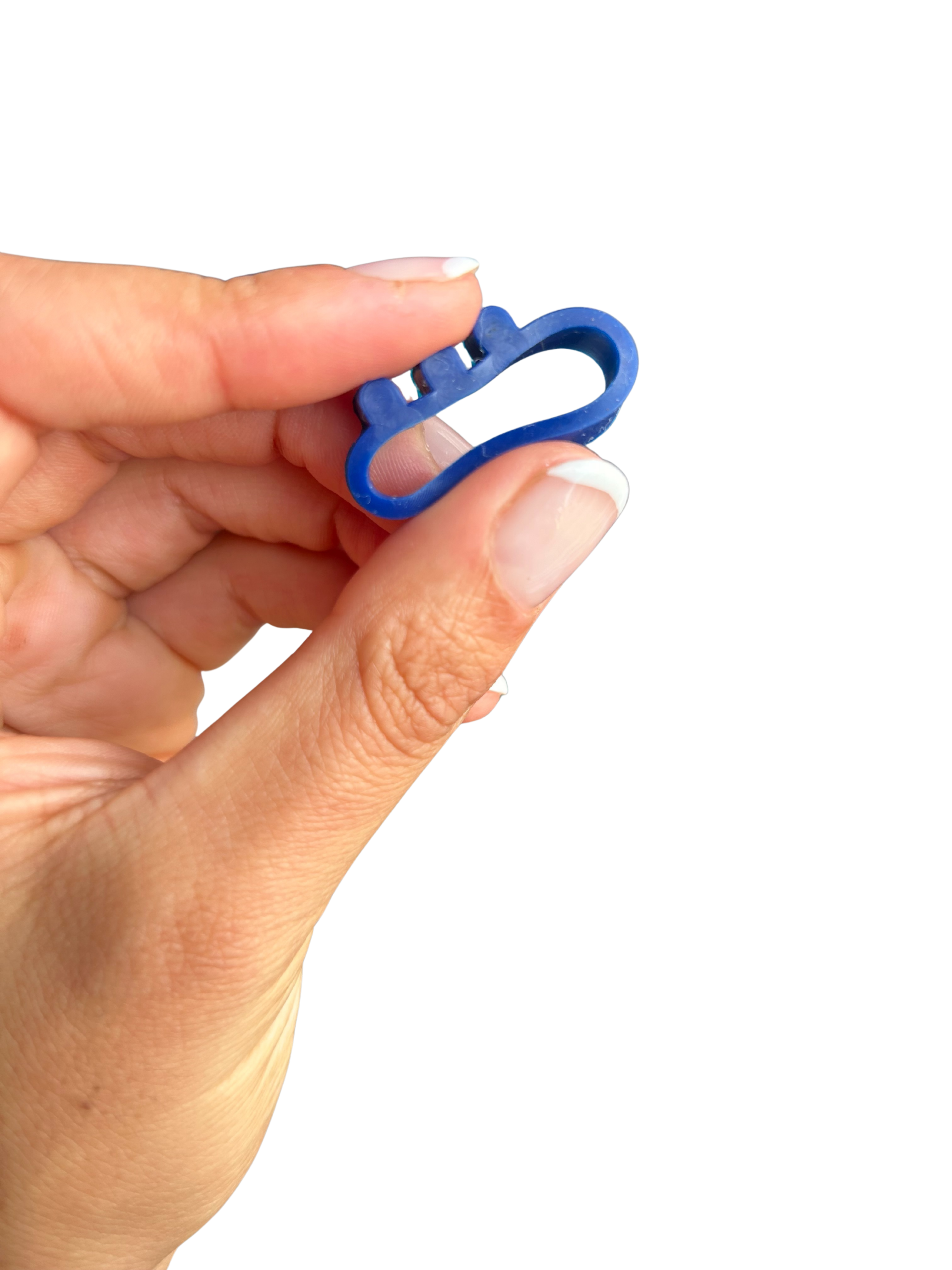 Pheelio device demonstrating its flexible material sliding onto an eye drop bottle